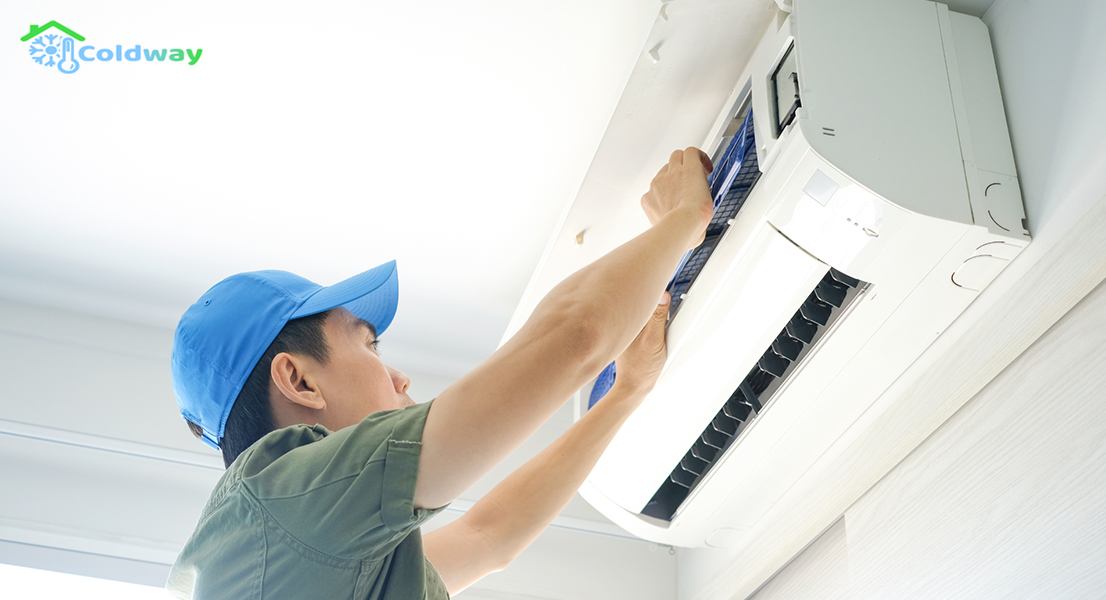 Repair person conducting maintenance on an air conditioner unit.