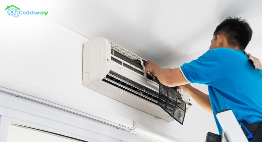 A technician repairing an air conditioner