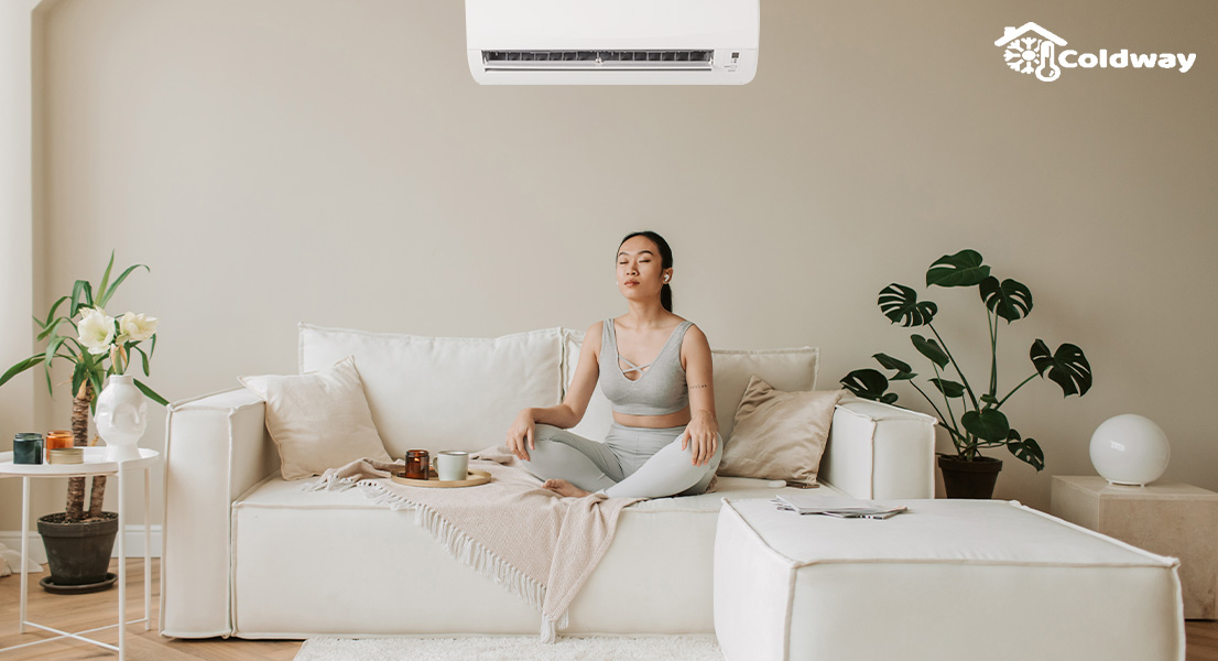 A woman enjoying the air conditioner